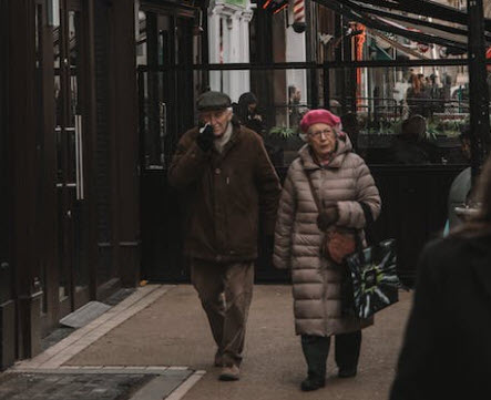 Elderly Couple Walking on the Sidewalk