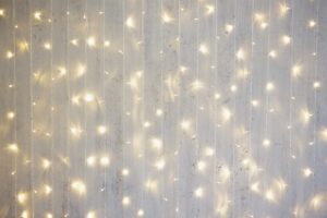 Christmas background - garland lights on grey wall